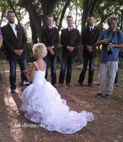 tiny flower girl with long ruffled train